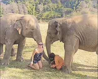  ?? SUBMITTED PHOTO ?? Annie Hennessey and founder Lek Chailert feed elephants at the Elephant Nature Park in Chiang Mai.