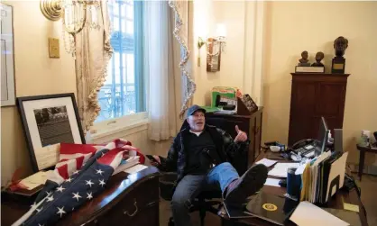  ?? Photograph: Saul Loeb/AFP/Getty Images ?? Richard Barnett in the speaker’s office during the Capitol attack in January. Barnett faces a series of federal charges over his alleged role in the insurrecti­on.