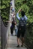  ?? STEVE RINGMAN/TRIBUNE NEWS SERVICES ?? The Lynn Canyon Suspension Bridge dangles above a creek.