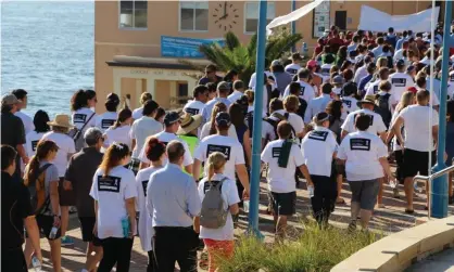  ??  ?? White Ribbon march: for every 10 men who feel safe walking home at night, only 6.3 women do – OECD. Photograph: Simone Ziaziaris/AAP