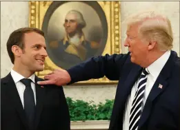  ??  ?? Donald Trump flicks away dandruff on Emmanuel Macron’s shoulder: ‘In the animal kingdom, grooming another male is usually a sign of deference’