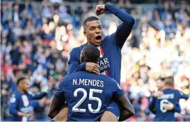  ?? (AFP) ?? PSG’S Kylian Mbappe celebrates with Nuno Mendes after scoring against Auxerre on Saturday