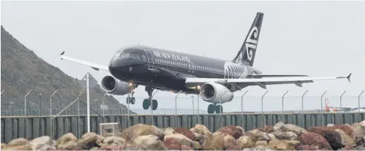  ?? Picture / Mark Mitchell ?? An Air New Zealand A320 lands in crosswinds at Wellington. Passenger revenue is down.