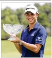  ??  ?? Collin Morikawa holds his trophy after winning the Workday Charity Open golf tournament Sunday in Dublin, Ohio.
