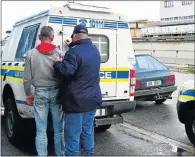  ?? Picture: EUGENE COETZEE ?? GOT YOU: Police arrest one of the suspects for the hijacking of the Ford taxi