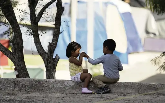  ?? ERIC GAY AP ?? Children played at a camp of asylum seekers last month in Matamoros, Mexico. The camp’s so-called sidewalk school went to virtual learning and has blossomed.