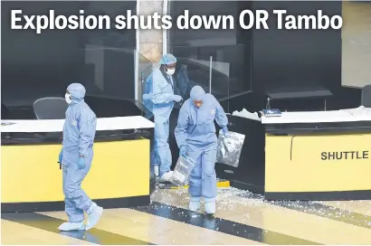  ?? Picture: Neil McCartney ?? AFTERMATH. Crime scene technician­s collect evidence after a small controlled explosion of a bag at OR Tambo Internatio­nal Airport yesterday.