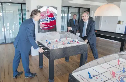  ?? PHIL CARPENTER ?? Brian Salpeter, left, senior vice-president developmen­t of Eastern Canada for Cadillac Fairview, with Daniel Peritz, senior vice-president at Canderel, play table hockey at the Tour des Canadiens 1. The tower’s 555 units sold rapidly, and a second...