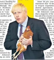  ??  ?? The Prime Minister inspects poultry during a visit to rally support for his farming plans post-Brexit at Shervingto­n Farm, near Newport, in Sout South Wales a es