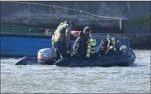  ??  ?? „ Royal Navy bomb disposal divers in King V George Dock, close to London City Airport, where the bomb was found.