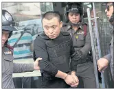  ?? PHOTOS BY PATIPAT JANTHONG ?? LEFT Ma Geng, one of four Mongolian suspects, is detained after the failed robbery.