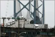  ?? ASSOCIATED PRESS FILE PHOTO ?? Trucks cross the Ambassador Bridge from Windsor, Ontario, into Detroit in 2018.