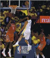  ??  ?? Klay Thompson of the Warriors shoots between the Rockets’ Clint Capela, left, and James Harden for two of his 35 points in Game 6 of the Western Conference finals at Oracle Arena.