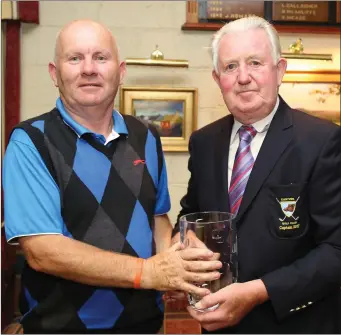  ??  ?? Kanturk Golf Club Captain Dan Joe Daly making a presentati­on to Oliver Deady, Ballycloug­h, who won second prize on Captain’s Day.