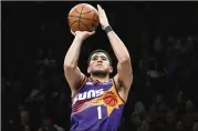  ?? MARY ALTAFFER/AP ?? Suns guard Devin Booker just turned 26 a few months ago and already has 12,000 points. Booker had three straight games with 40 or more points in December.