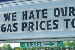  ?? ?? Pump-price surge: The sign is “our way of letting the customer know that we feel their pain,” says Minnesota gas-station owner Chuck Graff.