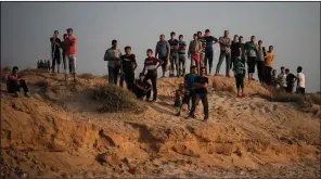  ?? AP/FELIPE DANA ?? Palestinia­n protesters gather Sunday on the beach in the Gaza Strip city of Beit Lahiya, near the border with Israel.