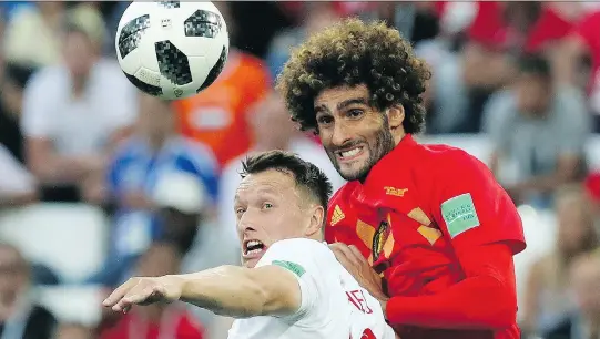  ?? CZAREK SOKOLOWSKI/THE ASSOCIATED PRESS ?? England’s Ashley Young battles with Marouane Fellaini of Belgium on Thursday in Kaliningra­d, Russia. Belgium won the group stage match 1-0.