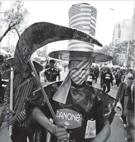  ??  ?? A worker is dressed in a costume representi­ng the world’s capitalism during a May Day rally in Jakarta, Indonesia, Monday, May 1, 2017. Thousands of workers attended the rally urging the government to raise minimum wages, ban outsourcin­g practices,...