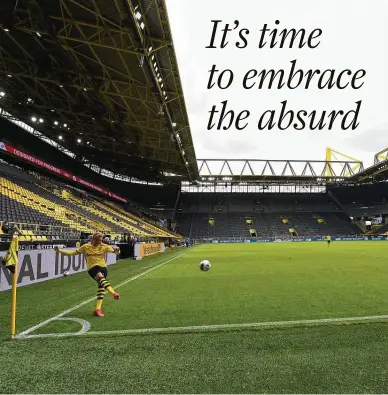  ?? Martin Meissner / Associated Press ?? Borussia Dortmund’s Erling Haaland takes a corner kick Saturday in his team’s 4-0 home win over Schalke with no fans in the stands. The German Bundesliga is the world’s first major pro sports league to restart amid the pandemic.