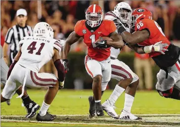  ?? CURTIS COMPTON / CCOMPTON@AJC.COM ?? Tailback Sony Michel (1) and Georgia made running through Mississipp­i State appear easy, cruising 31-3 in Athens against an SEC West opponent most expected would provide a stern test.