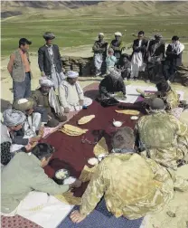  ?? PHOTO: NEW ZEALAND ARMY ?? Improving lives . . . New Zealand Defence Force personnel sit down to eat with villagers in Bamiyan province during a delivery of humanitari­an aid.