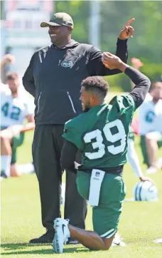  ?? ED MULHOLLAND/USA TODAY SPORTS ?? Jets defensive coordinato­r Kacy Rodgers is united with his son Kacy Rodgers II, who is a defensive back and new to the Jets after playing in the CFL.