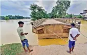  ?? — PTI ?? A damaged section of a bridge following floods in Nagaon district, on Monday.