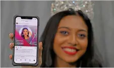  ?? — Bernama photo ?? Dheper shows the Miss Teen Universe Instagram page where fans can vote for her.