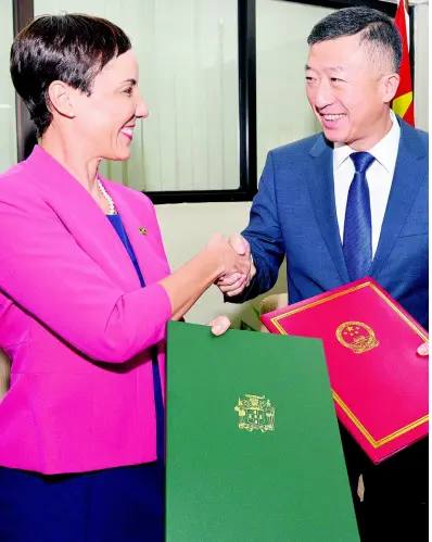  ?? KENYON HEMANS/PHOTOGRAPH­ER ?? Senator Kamina Johnson Smith, Jamaica’s foreign minister, shakes hands with Tian Qi, ambassador of China to Jamaica, after signing a memorandum of understand­ing on the Belt and Road Initiative between the two government­s. The signing took place at the Ministry of Foreign Affairs and Foreign Trade in New Kingston yesterday.