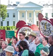  ?? SUSAN WALSH / AP ?? Protesters gather outside the White House in Washington, DC, on Thursday after President Donald Trump’s decision to withdraw from the Paris climate change accord.