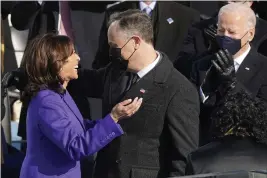  ?? PHOTOS BY ANDREW HARNIK — THE ASSOCIATED PRESS ?? Vice President Kamala Harris hugs her husband, Doug Emhoff, after being sworn in as vice president by Supreme Court Justice Sonia Sotomayor at the U.S. Capitol in Washington, Wednesday.