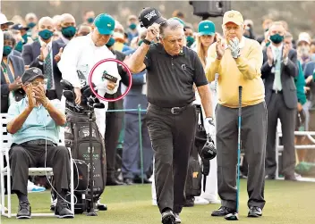  ??  ?? Poor judgment: Wayne player displays the Oncore golf balls (circled) for the TV cameras to pick up while father Gary prepares to tee off as an honorary starter