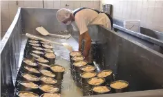  ??  ?? A Mennonite man works at a cheese factory in the Sabinal community.