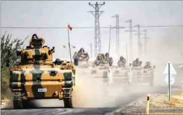  ?? AFP ?? Turkish Army tanks drive from the Turkish Syrian border city of Karkamis in the southern region of Gaziantep yesterday to the Syrian Turkish border town of Jarabulus.