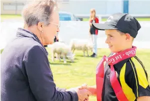  ?? ?? Club patron Jean Pedley presents Flynn Treleaven with the ribbon for best senior lamb.