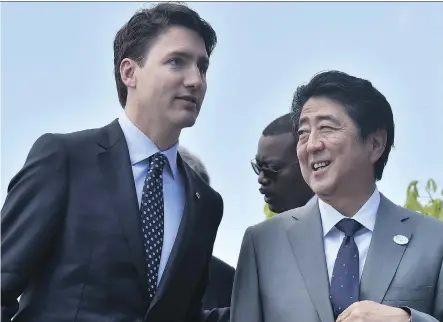  ?? TIZIANA FABI/AFP/GETTY IMAGES ?? Prime Minister Justin Trudeau is being urged to call Japanese Prime Minister Shinzo Abe, seen above during the G7 summit in May, before his trip to China in efforts to save the Comprehens­ive and Progressiv­e Agreement for Trans-Pacific Partnershi­p,...