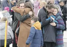  ?? RYAN REMIORZ, THE CANADIAN PRESS ?? Mourners console each other after funeral services for 4-year-old Jacob Gauthier on Thursday in Laval, Que. Gauthier was one of two children killed when a bus crashed into their daycare centre.