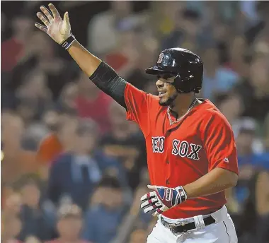  ?? STAFF PHOTO BY CHRISTOPHE­R EVANS ?? LIGHTING IT UP: Red Sox shortstop Xander Bogaerts celebrates after hitting a solo home run in the fourth inning of Friday night's loss to the Houston Astros at Fenway Park.