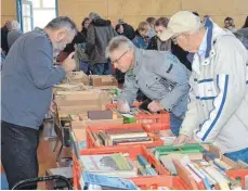  ?? FOTO: CHRISTOPH KLAWITTER ?? Die Bücherlieb­haber schauen sich an den Ständen im Bürgerhaus um, manche schauen ganz genau hin.