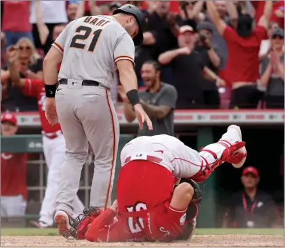  ?? DYLAN BUELL — GETTY IMAGES ?? Reds catcher Tyler Stephenson rolls backward after tagging out the Giants' Joey Bart in a game-ending collision at the plate in Cincinnati.