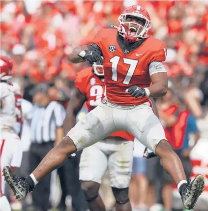  ?? TODD KIRKLAND/GETTY ?? Georgia’s Nakobe Dean celebrates during Saturday’s win over Arkansas at Sanford Stadium in Athens, Georgia.