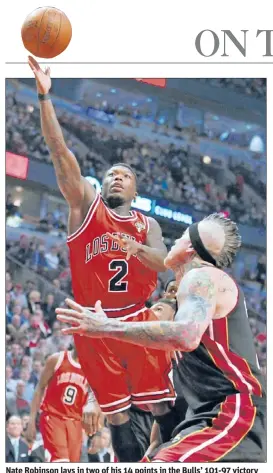  ?? | TOM CRUZE~SUN-TIMES ?? Nate Robinson lays in two of his 14 points in the Bulls’ 101-97 victory over the Heat on Wednesday at the United Center.