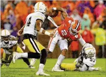  ?? STREETER LECKA / GETTY IMAGES ?? Antonio Simmons tries to bring down Clemson’s Kelly Bryant in last week’s game. The Tigers were in command during the first half but scored just three points after halftime.