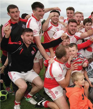  ??  ?? St Bride’s celebrate their league title and promotion at Ballygassa­n on Saturday. Pictures:Adrian Crawley