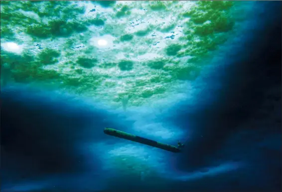  ?? (AP/NASA PSTAR RISE UP/Schmidt/Lawrence/Icefin) ?? A robot nicknamed Icefin operates under the sea ice in 2020 near McMurdo Station in Antarctica. The pencil-shaped robot is giving scientists their first look at the forces eating away at the Thwaites glacier.