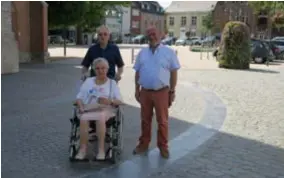  ?? FOTO JAN AUMAN ?? Schepen Bart Van Scharen met twee tevreden Wommelgemn­aren die de nieuwe Kerkplaats kruisen: Jozef Nelis en Mariette Luyts.