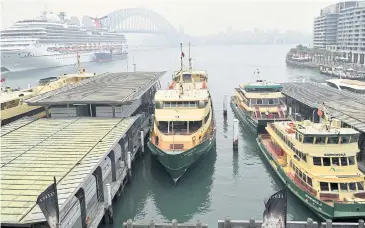  ?? REUTERS ?? Ferries stay docked at Circular Quay after services are cancelled as smoke haze from bushfires in New South Wales blankets the central business district in Sydney, Australia yesterday.