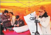  ?? PROVIDED TO CHINA DAILY ?? An entreprene­ur (right) demonstrat­es her textile products through livestream­ing during a promotiona­l activity launched by 1688.com, a B2B platform of Alibaba Group, in Nantong, Jiangsu province.