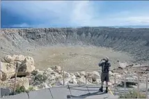  ??  ?? METEOR CRATER in Arizona presents an irresistib­le photo op.